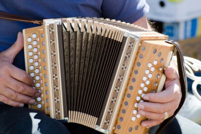 closeup-shot-male-playing-accordion-scaled.jpg