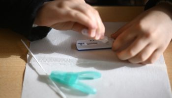 A student tests herself on the coronavirus with a rapid test at the Freiherr vom Stein school in Bonn, western Germany, on May 17, 2021. - Many day-care centres and schools will reopen this week with alternating classes in North-Rhine Westphalia. (Photo by Ina FASSBENDER / AFP)